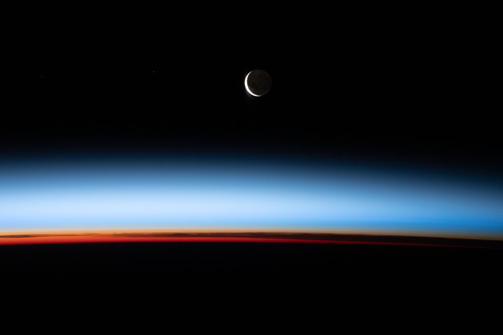 swaths of colors, black, red, and blue with crescent moon