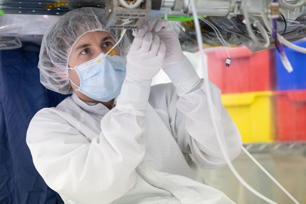 Aerospace Instrumentation Mechanical Engineer Matt Rubly assembling the payload for the COSI mission.