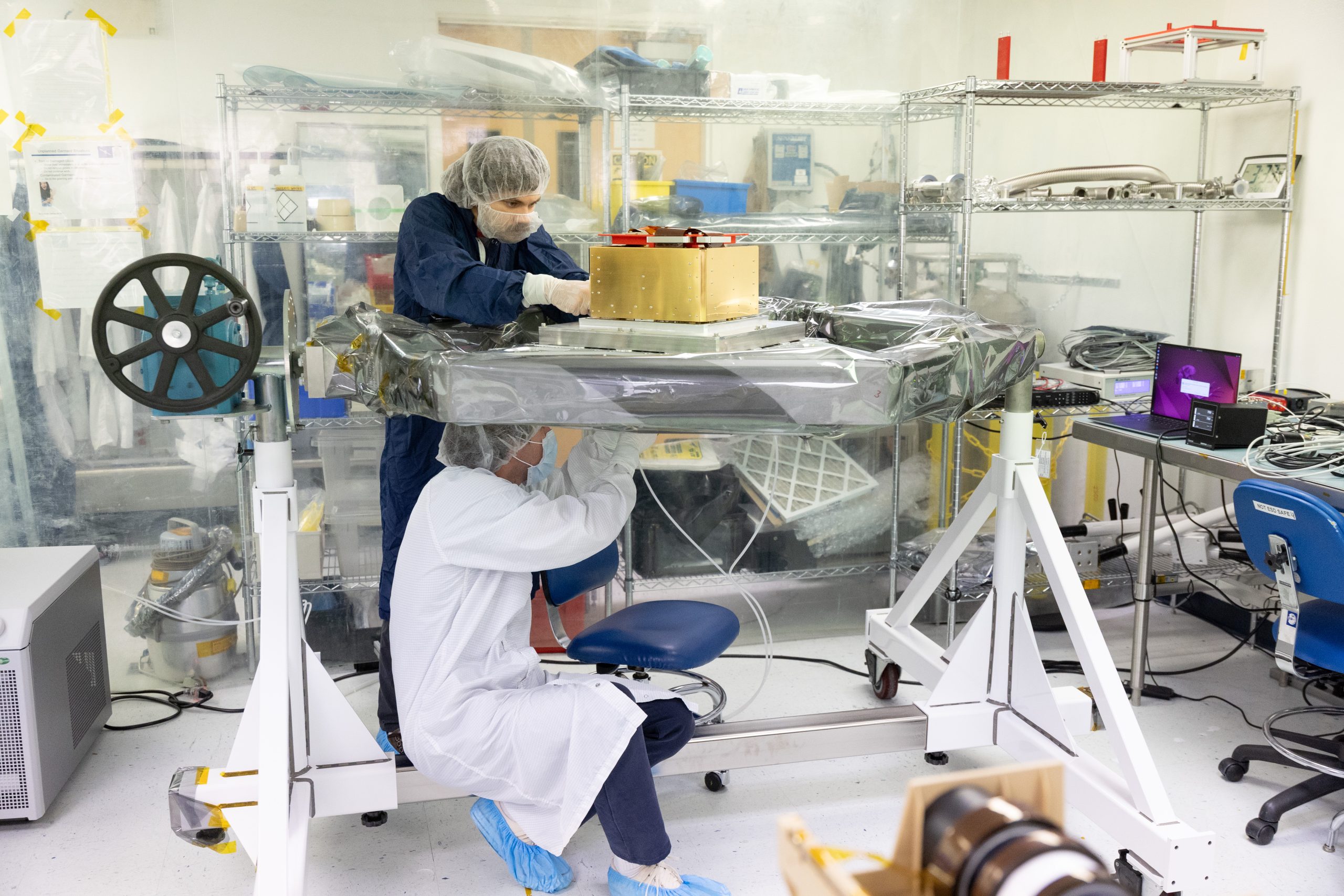 Aerospace Engineer Bradley Pafchek and Aerospace Instrumentation Mechanical Engineer Matt Rubly assembling a payload in an SSL clean room.